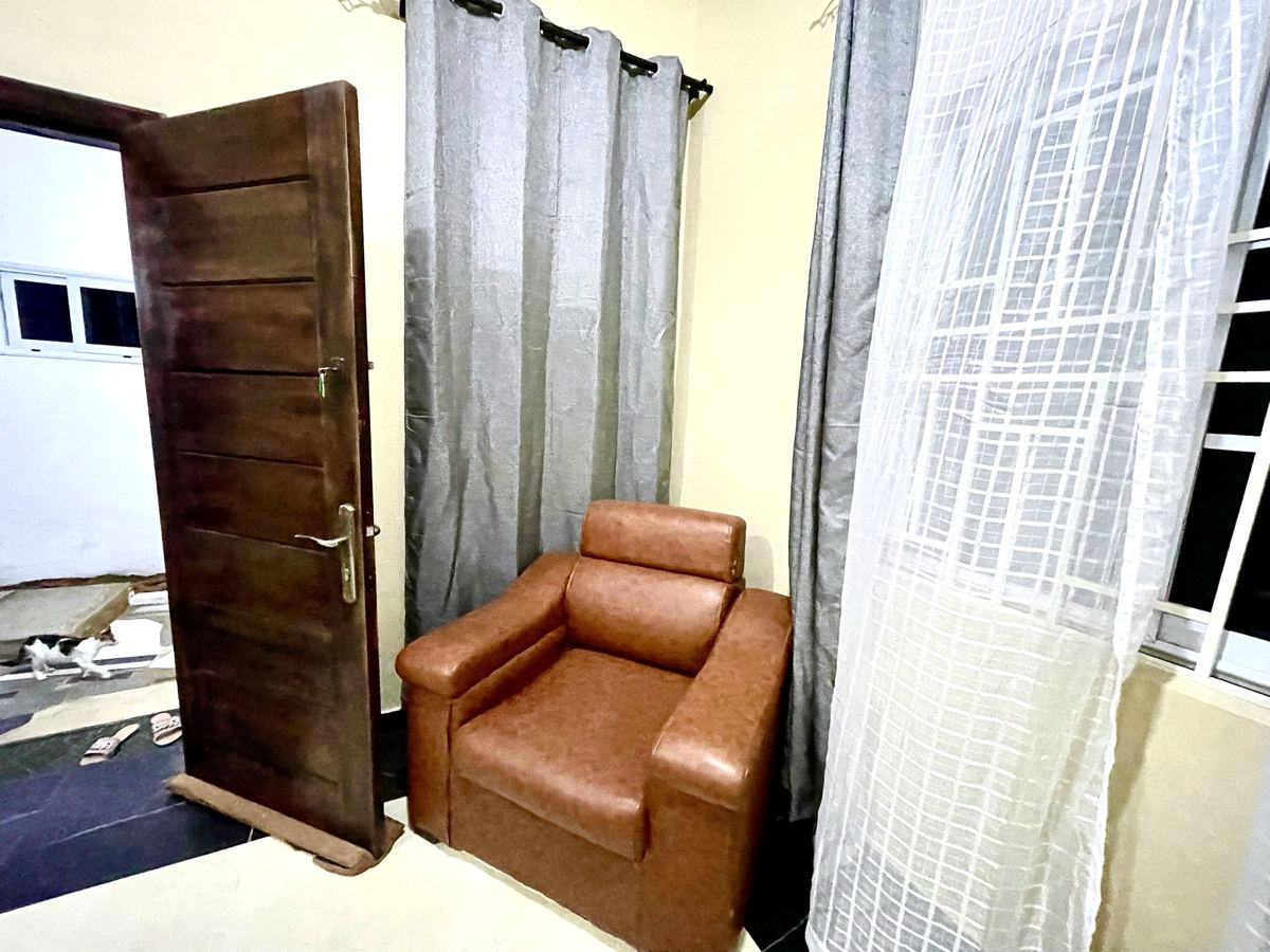 Economy studio suite with full size bed, AC, smart TV, sofa, dining table, mini fridge and ensuite bathroom
