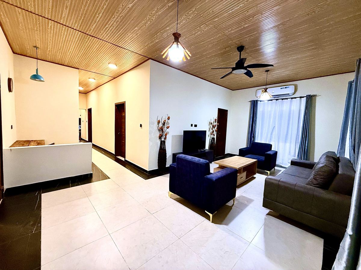 Spacious living room with ceiling fan