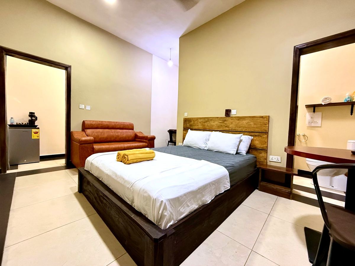 Superior queen studio suite with bed, sofa and mini fridge