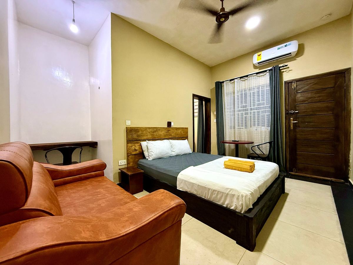 Superior queen studio suite with queen size bed, AC, smart TV, sofa, dining table, mini fridge and ensuite bathroom