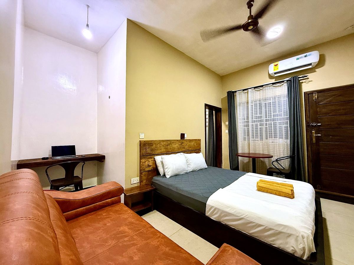 Superior queen studio suite with queen size bed, AC, smart TV, sofa, dining table, mini fridge and ensuite bathroom