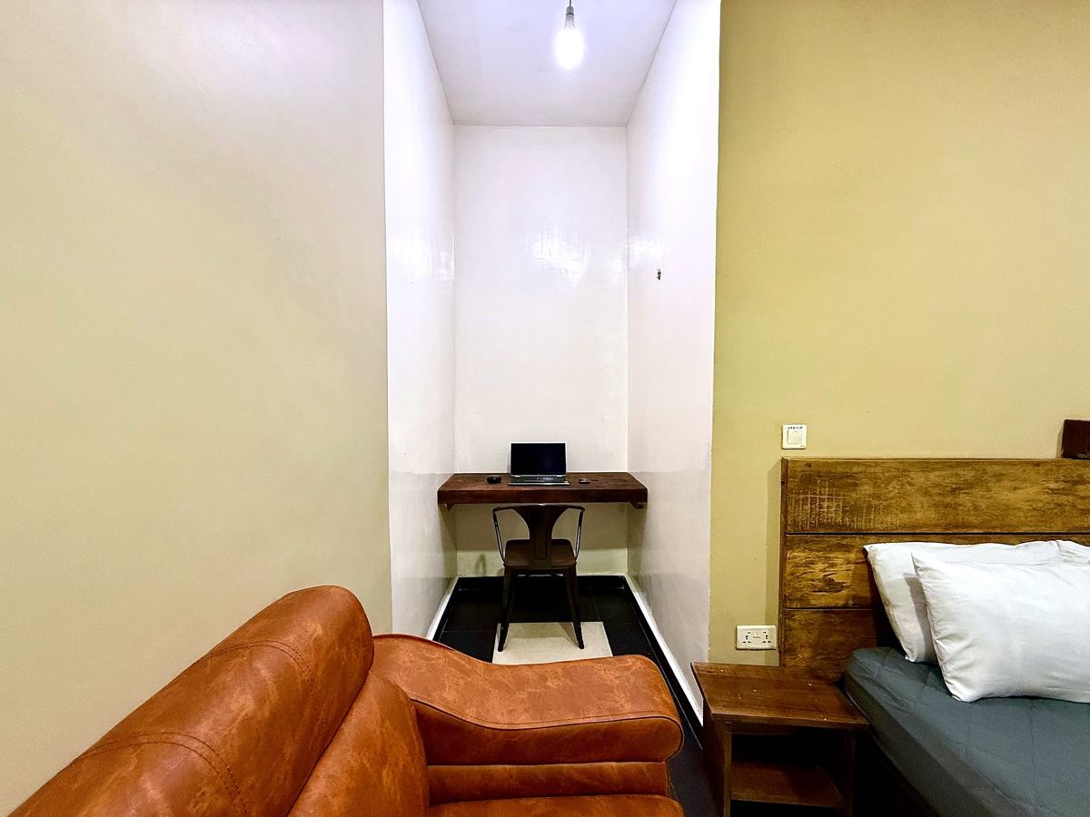 Superior queen studio suite with queen size bed, AC, smart TV, sofa, dining table, mini fridge and ensuite bathroom