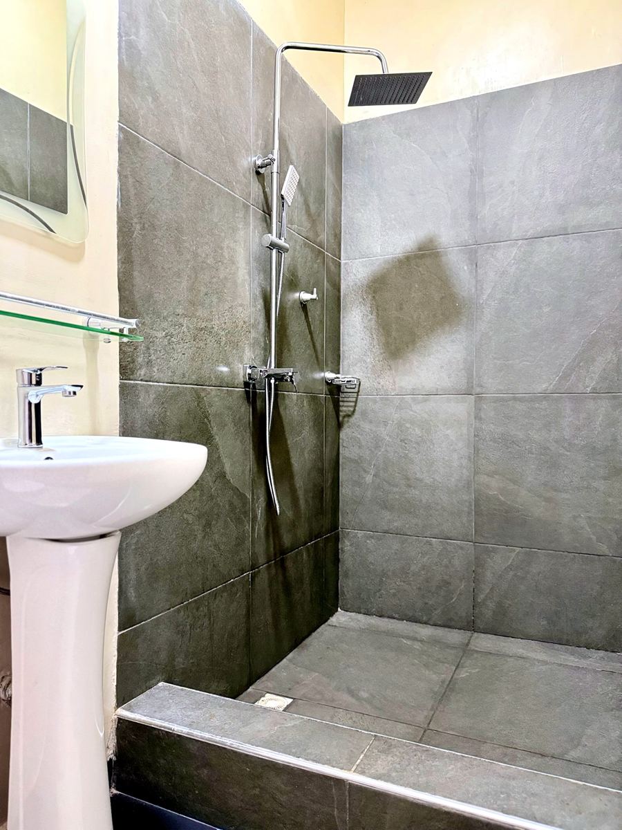 Queen studio suite bathroom with rainfall shower